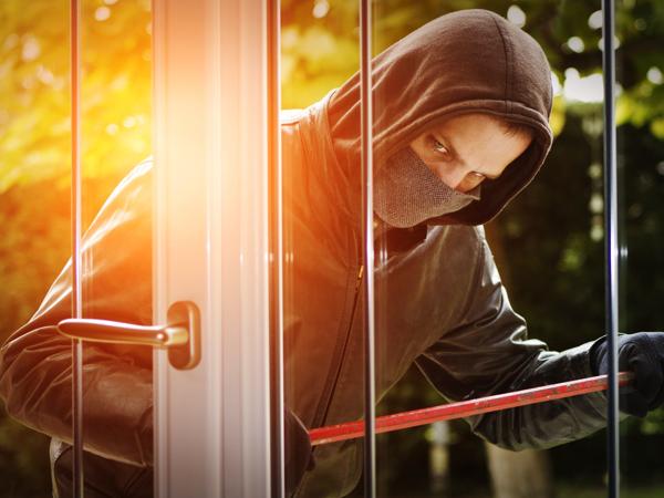 Burglar breaking into a house