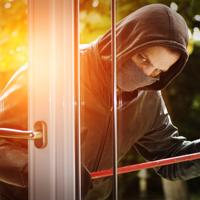 Burglar breaking into a house