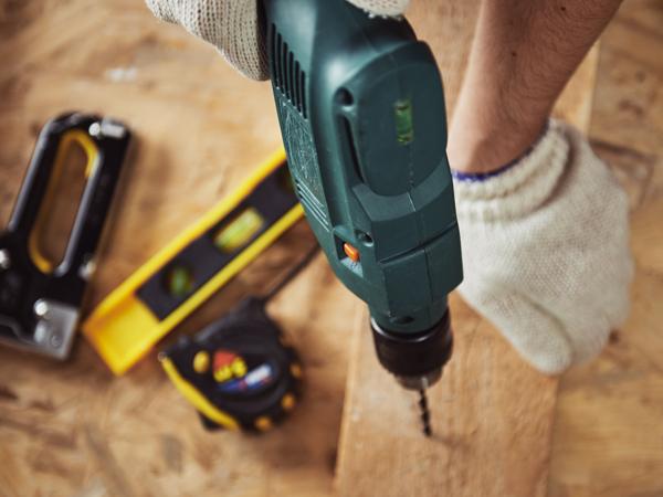 Carpenter using drill