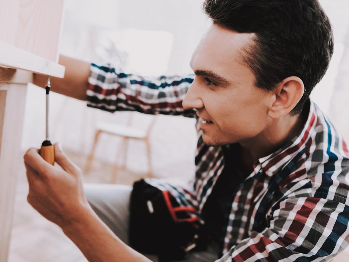 Man building wooden bookshelf