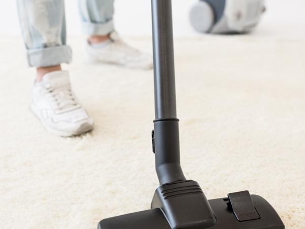 Woman vacuuming carpet