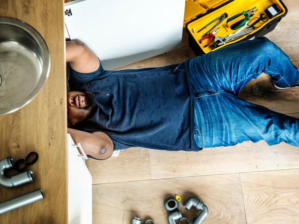 Plumber repairing kitchen sink