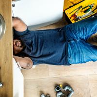 Plumber repairing kitchen sink